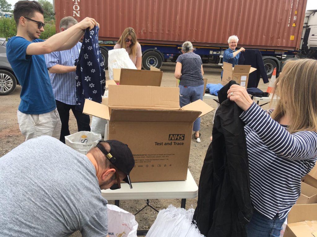 people helping to pack donations