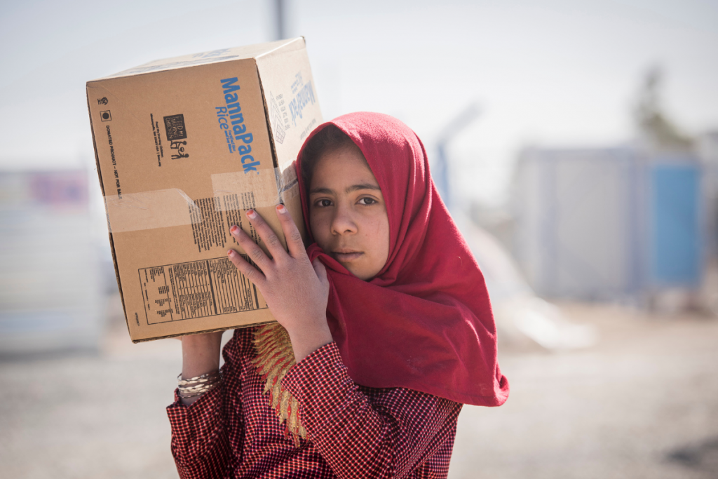 girl carrying box on shoulder