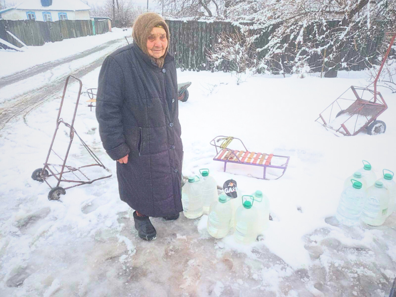 elderly woman standing next to water